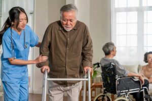 Older adult reviewing a care plan with a family member in a bright assisted living apartment.