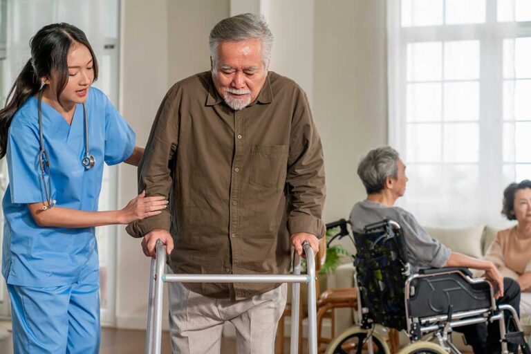 Older adult reviewing a care plan with a family member in a bright assisted living apartment.